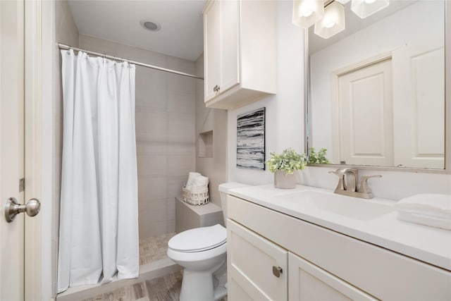 1007 W 43rd St, Houston, TX 77018 - full bathroom featuring vanity, toilet, tiled shower, and wood finished floors