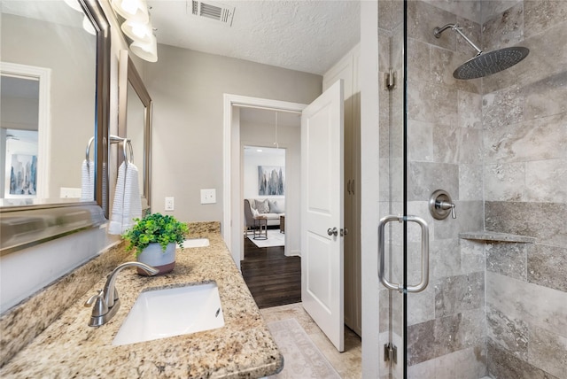 1007 W 43rd St, Houston, TX 77018 - bathroom featuring a stall shower, double vanity, and wood finished floors