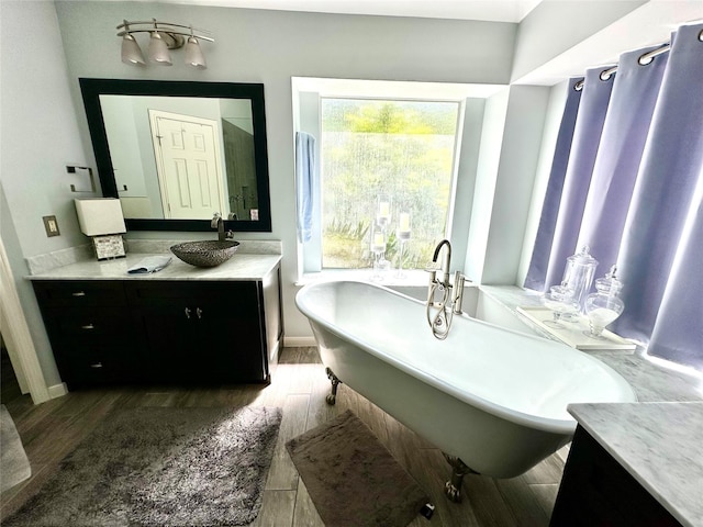 8910 Everhart Ln, Houston, TX 77040 - bathroom featuring vanity, a freestanding tub, wood finished floors, and baseboards