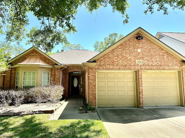 8910 Everhart Ln, Houston, TX 77040 - view of front of home with a garage, concrete driveway, brick siding, and roof with shingles