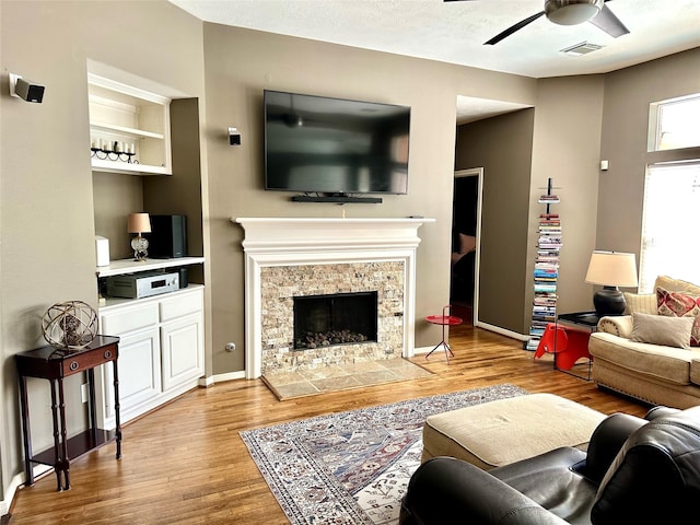 8910 Everhart Ln, Houston, TX 77040 - living area with a ceiling fan, wood finished floors, a fireplace, and baseboards