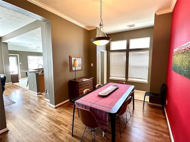 8910 Everhart Ln, Houston, TX 77040 - dining space with baseboards, ornamental molding, and hardwood / wood-style flooring