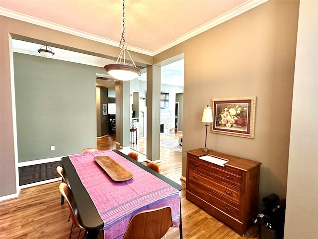 8910 Everhart Ln, Houston, TX 77040 - dining space featuring crown molding, light wood-style floors, and baseboards