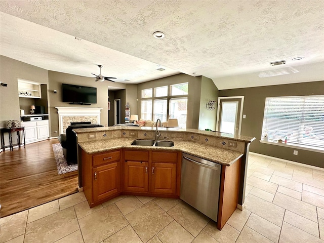 8910 Everhart Ln, Houston, TX 77040 - kitchen with stainless steel dishwasher, a sink, a ceiling fan, a textured ceiling, and open floor plan