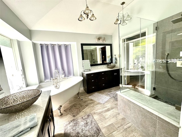 8910 Everhart Ln, Houston, TX 77040 - full bathroom with vanity, vaulted ceiling, a shower stall, and a freestanding tub