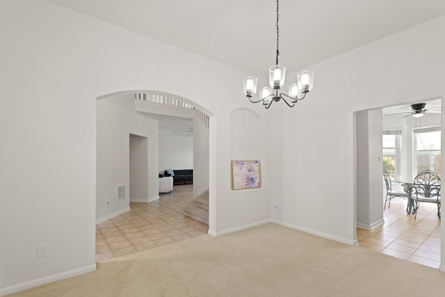 6426 Savannah Pines Dr, Katy, TX 77449 - carpeted spare room featuring arched walkways, tile patterned floors, a chandelier, and baseboards