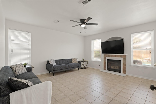 6426 Savannah Pines Dr, Katy, TX 77449 - living area with a ceiling fan, baseboards, light tile patterned flooring, and a tile fireplace