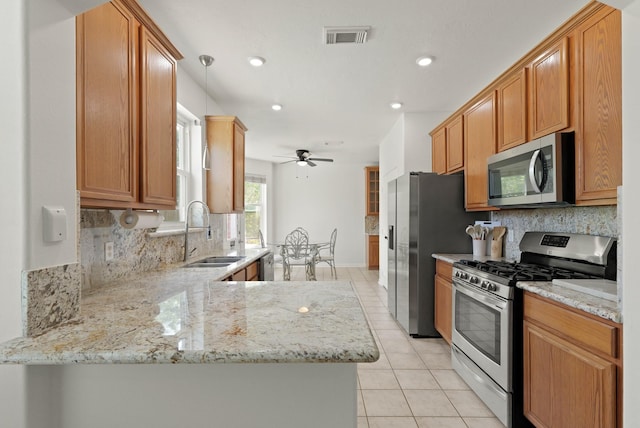 6426 Savannah Pines Dr, Katy, TX 77449 - kitchen featuring appliances with stainless steel finishes, a sink, light tile patterned floors, tasteful backsplash, and recessed lighting
