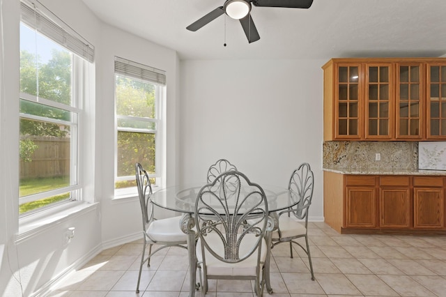 6426 Savannah Pines Dr, Katy, TX 77449 - dining space featuring light tile patterned floors, ceiling fan, and baseboards