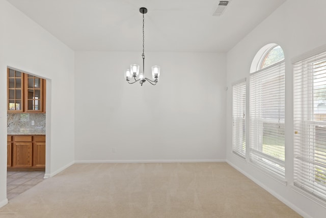 6426 Savannah Pines Dr, Katy, TX 77449 - unfurnished dining area featuring light carpet, a chandelier, and baseboards