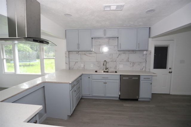 345 Byrd St, Vidor, TX 77662 - kitchen with wall chimney range hood, dishwasher, a sink, light countertops, and tasteful backsplash