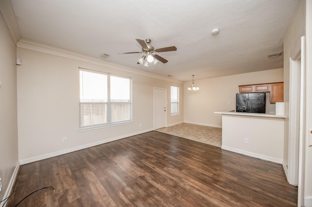 12510 Panther Place Dr, Houston, TX 77099 - unfurnished living room featuring dark wood finished floors, ornamental molding, ceiling fan, a chandelier, and baseboards
