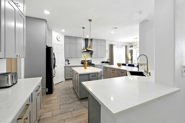 16522 N Canyon Trace Dr, Houston, TX 77095 - kitchen with gray cabinetry, a sink, freestanding refrigerator, stainless steel gas range, and recessed lighting