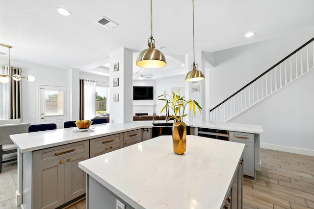 16522 N Canyon Trace Dr, Houston, TX 77095 - kitchen with gray cabinets, a kitchen island, open floor plan, ceiling fan, and recessed lighting