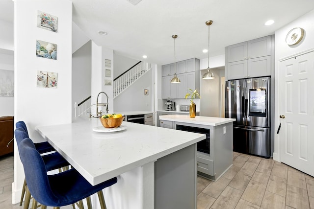 16522 N Canyon Trace Dr, Houston, TX 77095 - kitchen with gray cabinets, a peninsula, a kitchen island, a sink, and recessed lighting