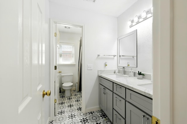 16522 N Canyon Trace Dr, Houston, TX 77095 - full bathroom featuring double vanity, toilet, and baseboards