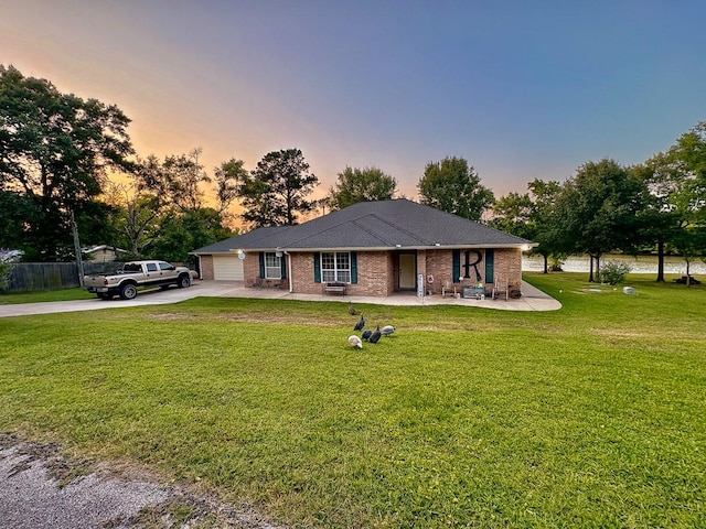 18 Joe Werner Ln, Huntsville, TX 77320 - ranch-style house with concrete driveway, a garage, brick siding, and covered porch