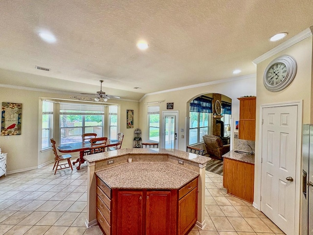 18 Joe Werner Ln, Huntsville, TX 77320 - kitchen with crown molding, arched walkways, a center island, plenty of natural light, and a sink
