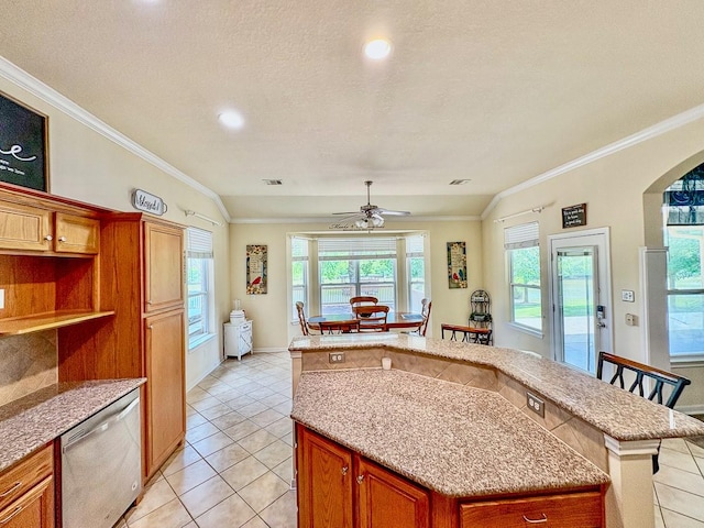 18 Joe Werner Ln, Huntsville, TX 77320 - kitchen with dishwasher, light tile patterned flooring, a ceiling fan, ornamental molding, and arched walkways