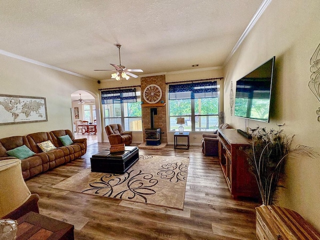 18 Joe Werner Ln, Huntsville, TX 77320 - living area with a wood stove, ceiling fan, crown molding, wood finished floors, and a textured ceiling