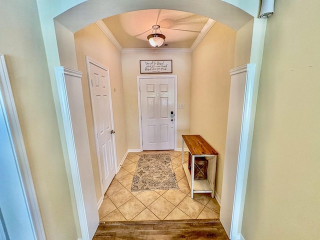18 Joe Werner Ln, Huntsville, TX 77320 - entryway featuring arched walkways, light tile patterned flooring, ornamental molding, and baseboards