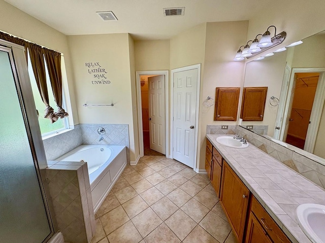 18 Joe Werner Ln, Huntsville, TX 77320 - bathroom with double vanity, a garden tub, tile patterned floors, and a spacious closet