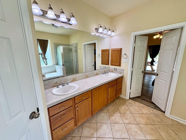 18 Joe Werner Ln, Huntsville, TX 77320 - full bathroom featuring a stall shower, double vanity, healthy amount of natural light, and tile patterned floors