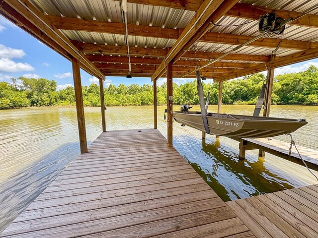 18 Joe Werner Ln, Huntsville, TX 77320 - dock area with boat lift, a water view, and view of wooded area