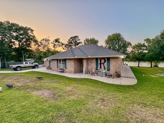 18 Joe Werner Ln, Huntsville, TX 77320 - back of property at dusk featuring a patio area and brick siding