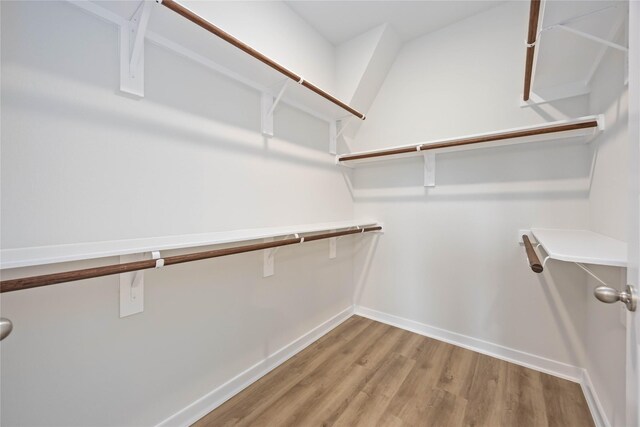 540 Barton Place Dr, Cleveland, TX 77327 - walk in closet with wood finished floors