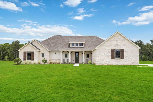 540 Barton Place Dr, Cleveland, TX 77327 - view of front facade featuring stone siding, covered porch, a front yard, and roof with shingles