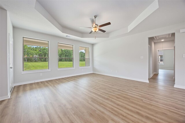540 Barton Place Dr, Cleveland, TX 77327 - unfurnished room featuring attic access, a tray ceiling, plenty of natural light, and a ceiling fan