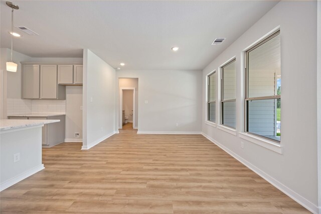 540 Barton Place Dr, Cleveland, TX 77327 - unfurnished living room with light wood-style floors, baseboards, and recessed lighting