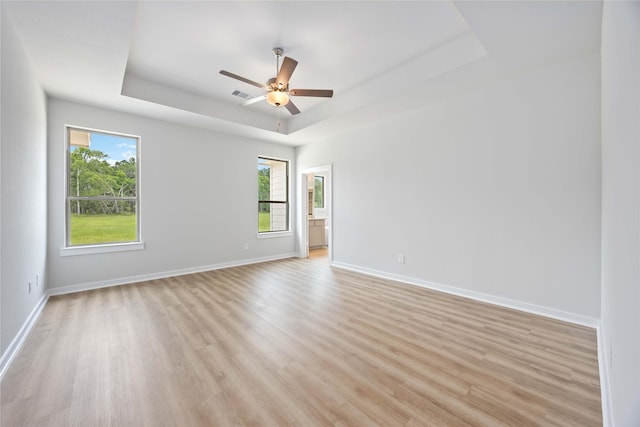 540 Barton Place Dr, Cleveland, TX 77327 - spare room featuring a raised ceiling, healthy amount of natural light, and light wood-style flooring