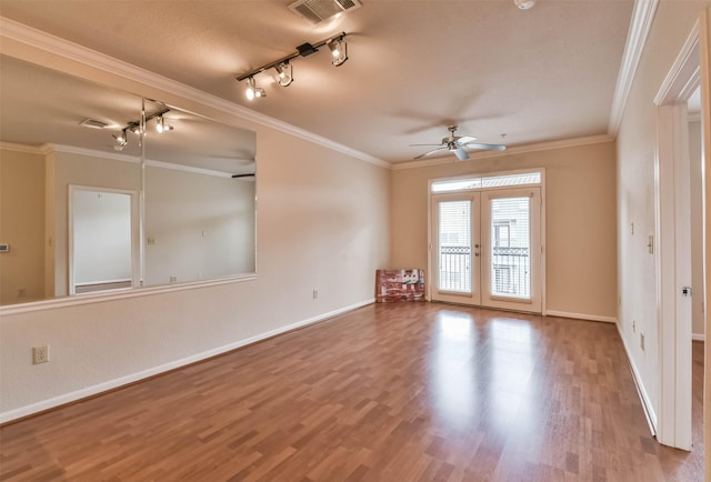 1711 Old Spanish Trl Unit 406, Houston, TX 77054 - spare room featuring a ceiling fan, track lighting, wood finished floors, baseboards, and crown molding