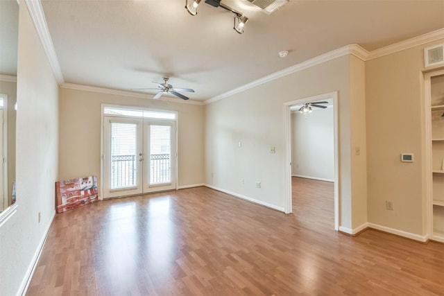 1711 Old Spanish Trl Unit 406, Houston, TX 77054 - spare room featuring ceiling fan, ornamental molding, wood finished floors, french doors, and baseboards
