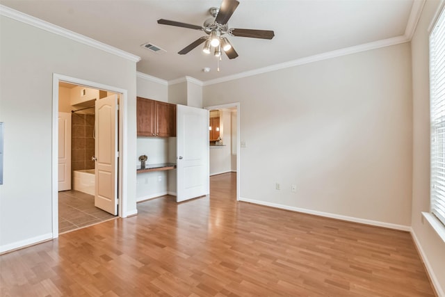 1711 Old Spanish Trl Unit 406, Houston, TX 77054 - unfurnished bedroom with light wood-style floors, crown molding, baseboards, and multiple windows