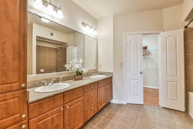 1711 Old Spanish Trl Unit 406, Houston, TX 77054 - full bath featuring tiled shower, tile patterned floors, double vanity, a bath, and a walk in closet