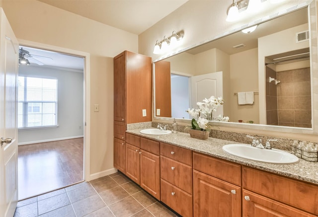 1711 Old Spanish Trl Unit 406, Houston, TX 77054 - full bathroom featuring double vanity, ceiling fan, tile patterned floors, baseboards, and a shower
