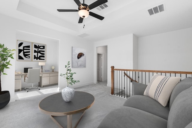31718 Hatcher Grove Ln, Fulshear, TX 77441 - living room with light carpet, a desk, ceiling fan, baseboards, and a raised ceiling