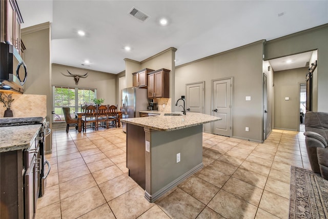 1586 Ancient Oak Ln, Conroe, TX 77301 - kitchen with appliances with stainless steel finishes, crown molding, decorative backsplash, light tile patterned floors, and recessed lighting