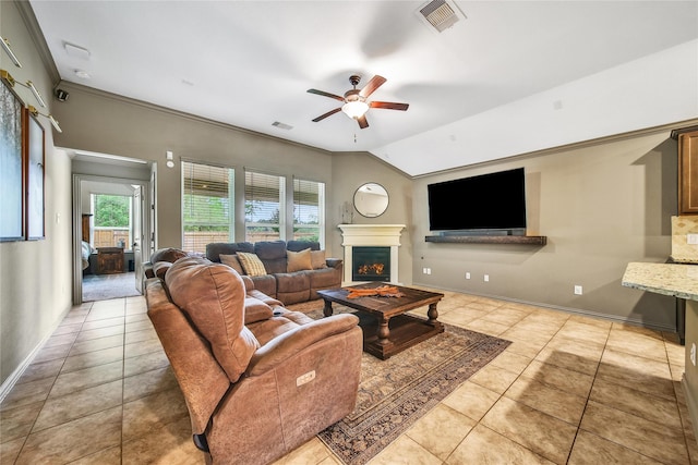 1586 Ancient Oak Ln, Conroe, TX 77301 - tiled living area with ceiling fan, a lit fireplace, lofted ceiling, and crown molding