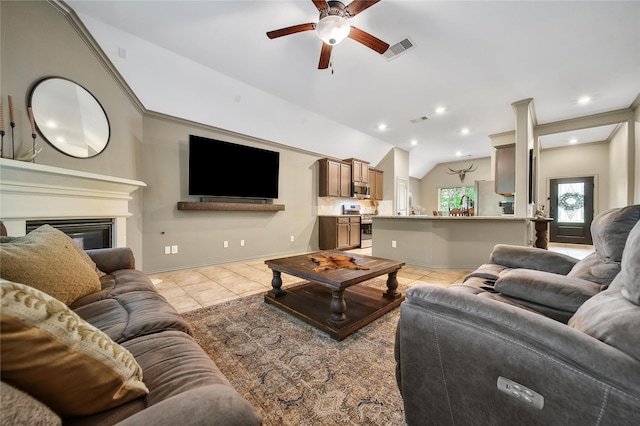 1586 Ancient Oak Ln, Conroe, TX 77301 - living area featuring lofted ceiling, a ceiling fan, light tile patterned flooring, a glass covered fireplace, and recessed lighting