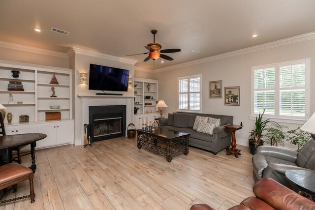 5950 Keith Rd, Lumberton, TX 77657 - living area featuring ceiling fan, healthy amount of natural light, light wood-type flooring, crown molding, and a fireplace