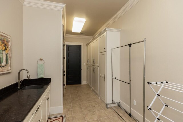 5950 Keith Rd, Lumberton, TX 77657 - kitchen with a sink, white cabinets, light tile patterned floors, crown molding, and baseboards
