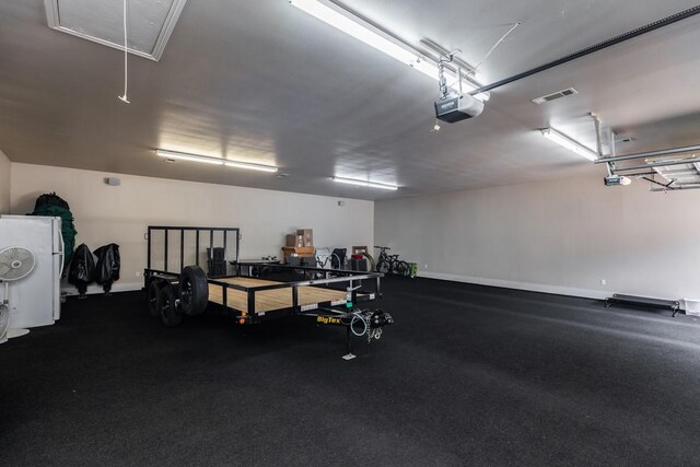 5950 Keith Rd, Lumberton, TX 77657 - garage featuring a garage door opener and baseboards