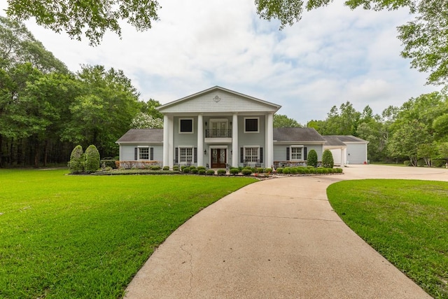 5950 Keith Rd, Lumberton, TX 77657 - greek revival house with a front yard, concrete driveway, a garage, and a balcony