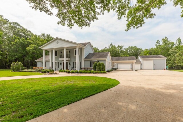 5950 Keith Rd, Lumberton, TX 77657 - greek revival house with a front lawn, driveway, and covered porch