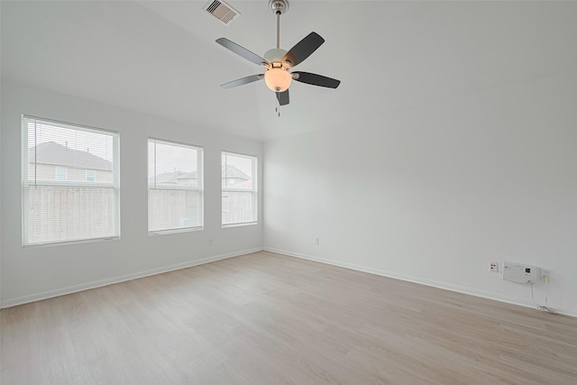 1219 Newsome Glenn Dr, Houston, TX 77090 - empty room with light wood finished floors, a ceiling fan, baseboards, and lofted ceiling