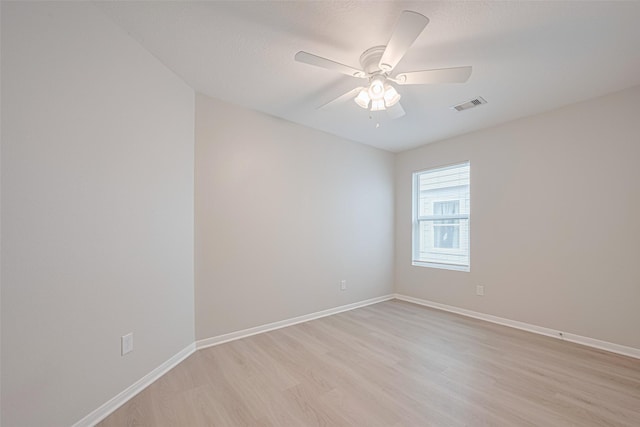 1219 Newsome Glenn Dr, Houston, TX 77090 - spare room featuring light wood-style flooring, a ceiling fan, and baseboards
